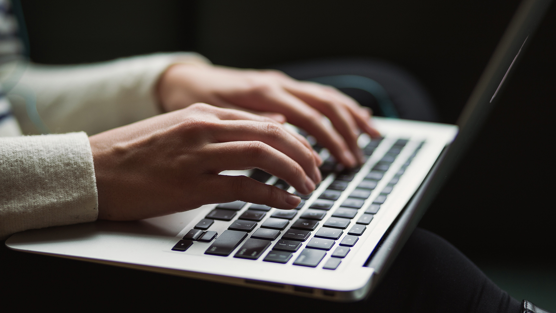 A person typing on a laptop